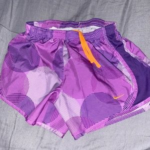 Nike purple athletic shorts with orange drawstring